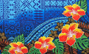 A flat-lay view of the Hibiscus, Plumeria Assortment Sarong (Style 13) featuring a vibrant Polynesian-inspired design. The pattern includes three large, bright red hibiscus flowers with orange-yellow highlights and smaller brown plumeria blossoms. The background is a deep royal blue, featuring intricate traditional Polynesian tribal motifs, tattoo-inspired geometric patterns, and lush green monstera and palm leaves.