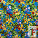 Tropical Hawaiian orchid print fabric in Kai Aqua blue with yellow florals and green palm leaves.