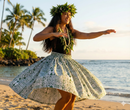Full-length view of a woman wearing a traditional Polynesian dress made from white polyester fabric featuring a bold black Hawaiian Tattoo (Kakau) and Tapa-inspired geometric pattern