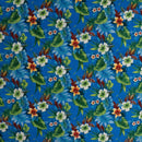 Royal blue Hawaiian floral print with white and orange hibiscus flowers for apparel and decor.